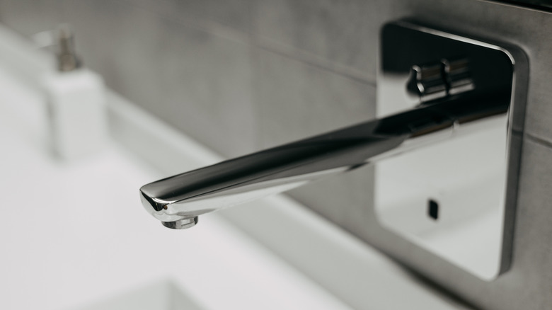 A close-up shot of a touchless faucet