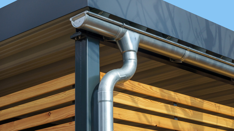 A metal gutter at the edge of a house