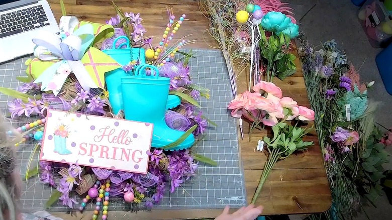 DIYing a spring wreath with rubber boots on top
