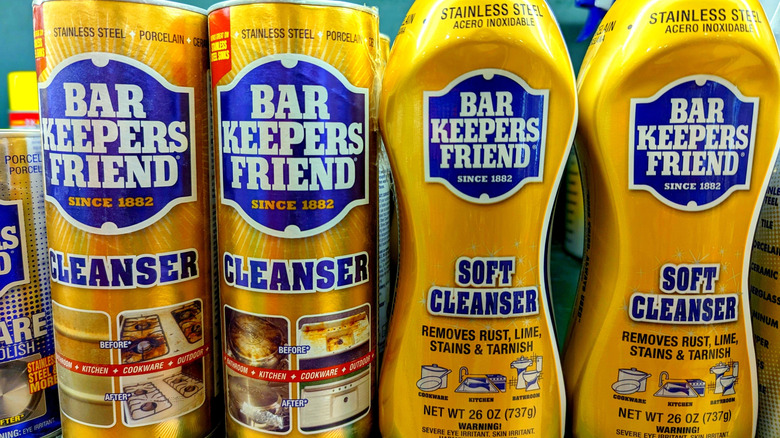 Cans and bottles of Bar Keepers Friend on a shelf in a store.