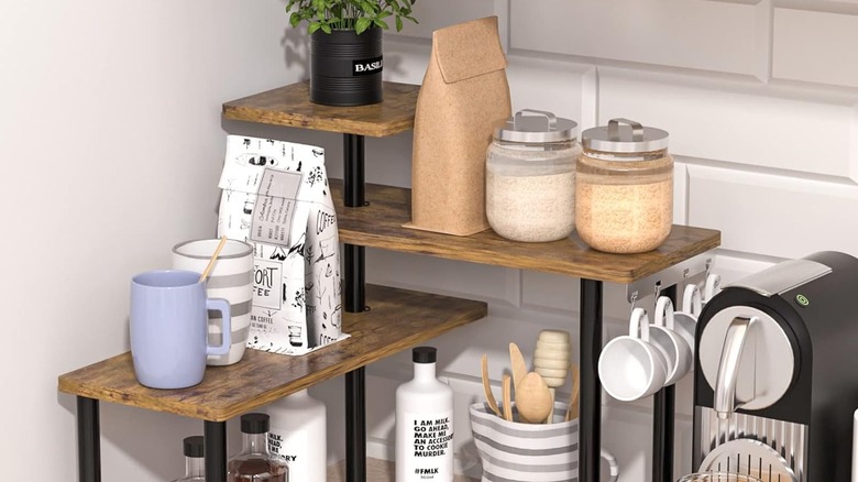 A three-tiered shelving unit from Amazon arranged in a kitchen corner and lined with items
