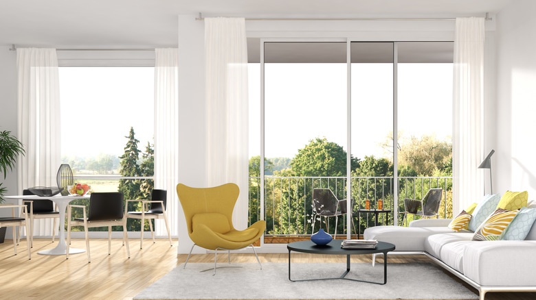 Bright living room with sheer curtains over sliding doors
