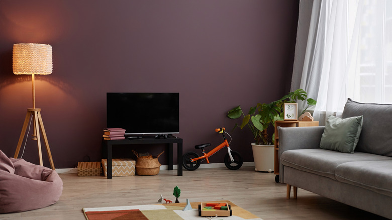Living room with dark purple walls.