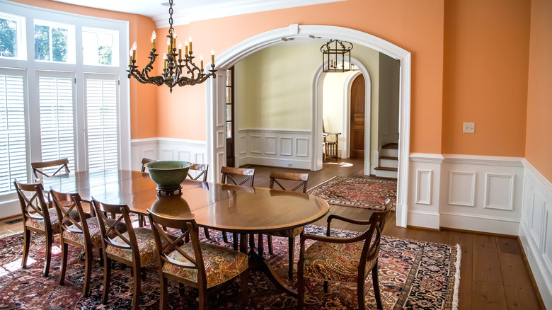 Dining room with orange walls.