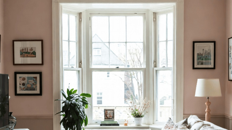 Sunny room with pale pink walls.