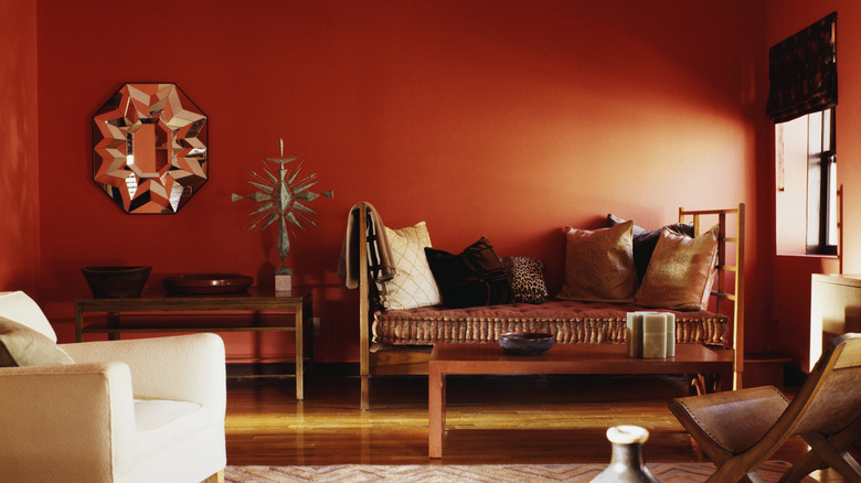 Guest room with rust orange walls.