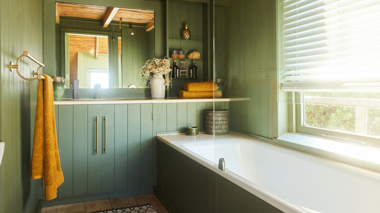 Sunny bathroom with sage green walls.
