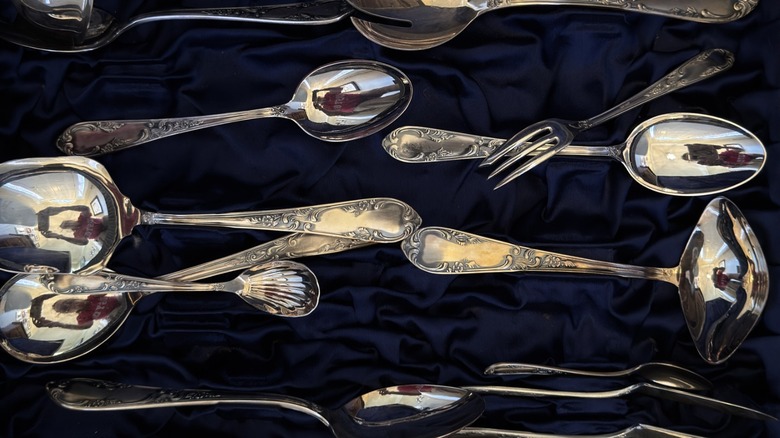 An assortment of vintage silverware including serving spoons
