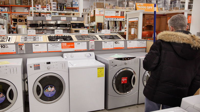 A customer looks at the washing machines in Home Depot
