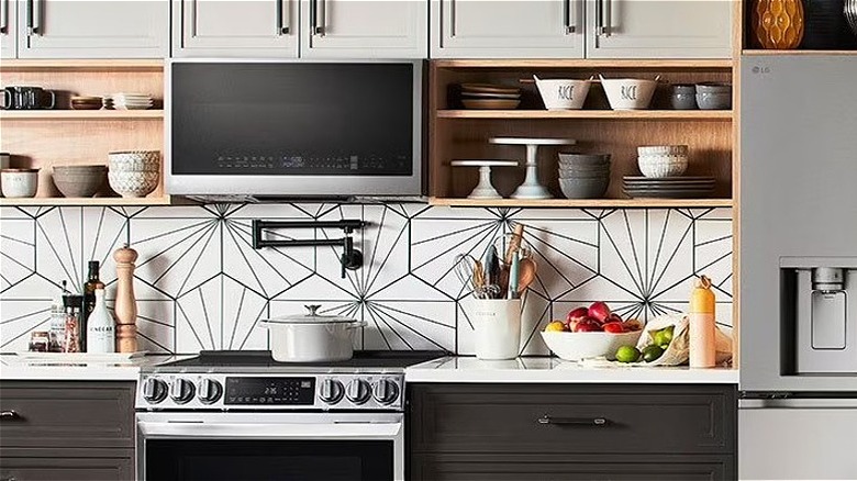 A contemporary open-style kitchen with built-in appliances