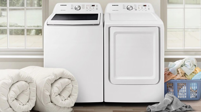 White washer and dryer sitting side-by-side in a laundry room