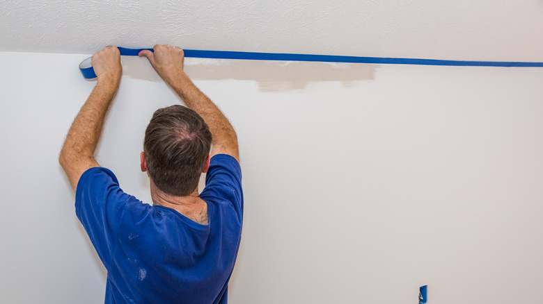 Person applying painter's tape