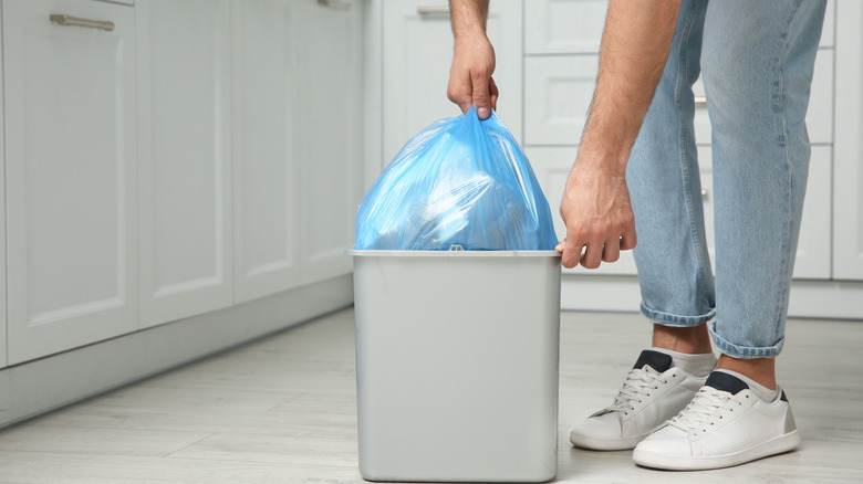 man taking out garbage