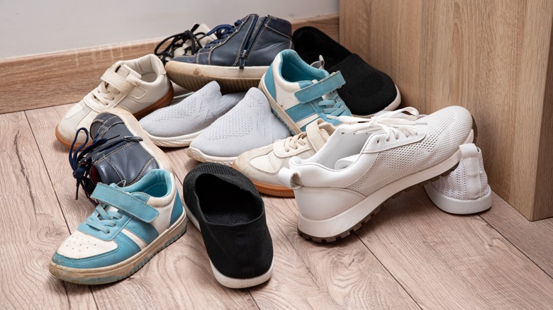 A pile of mostly mismatched shoes