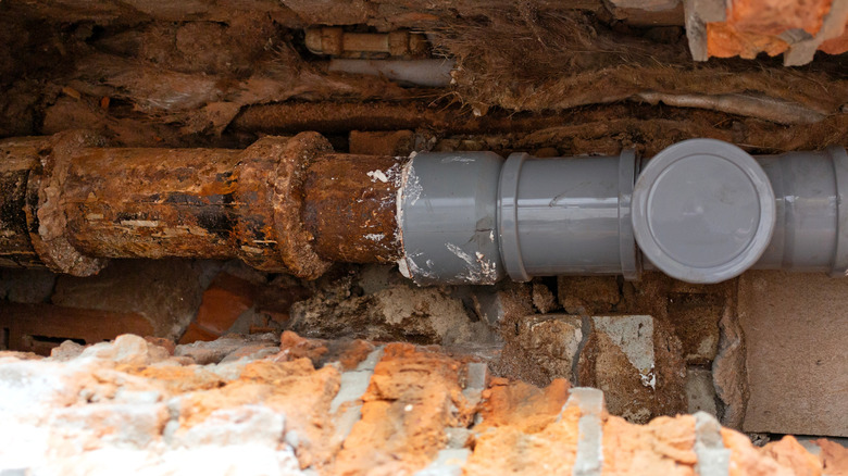 PVC pipe replacing part of old cast iron sewer line