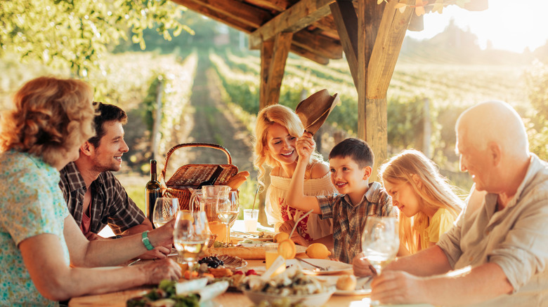 A family enjoying lunch under a gazebo