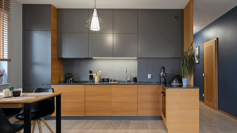 modern kitchen with inset gray upper cabinetry and wood lower cabinetry