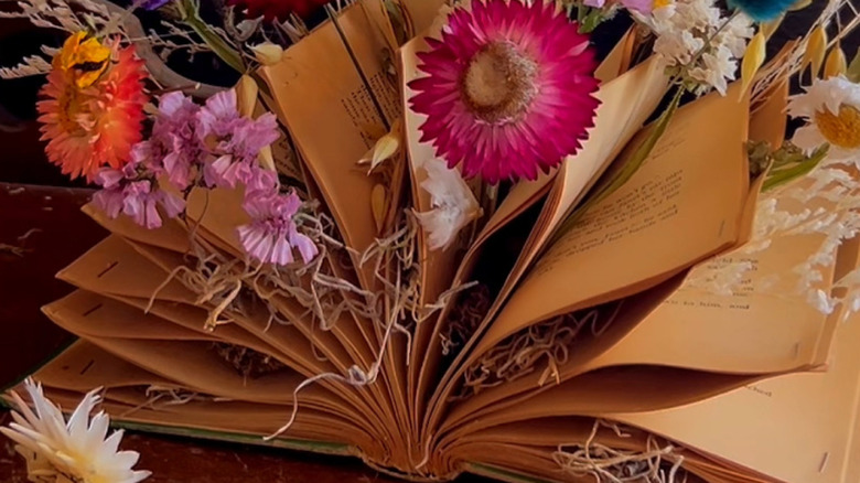 An old book being turned into a floral display