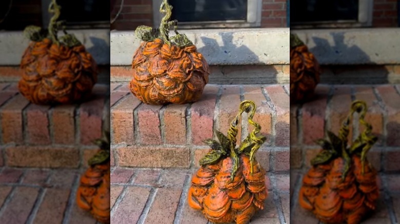 Two unique pumpkins on brick steps made out of oyster shells
