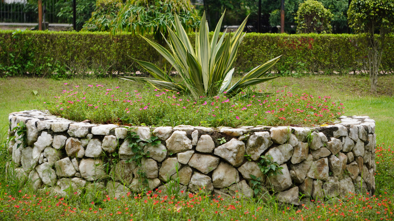 A rustic garden bed using stone.