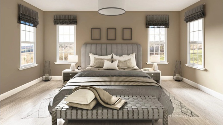 Universal khaki used on the walls in a bedroom and paired with similar neutral shades to give a warm, cozy feel