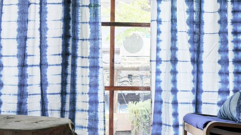 Window with an indigo shibori curtain.
