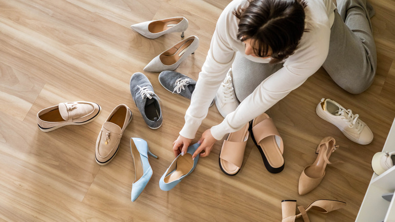 woman on the floor organizing shoes