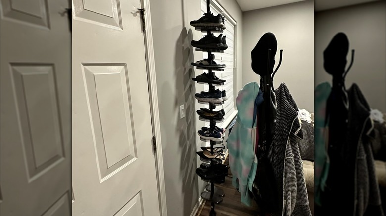 The Cisiree vertical shoe rack placed in an entryway next to a coat rack