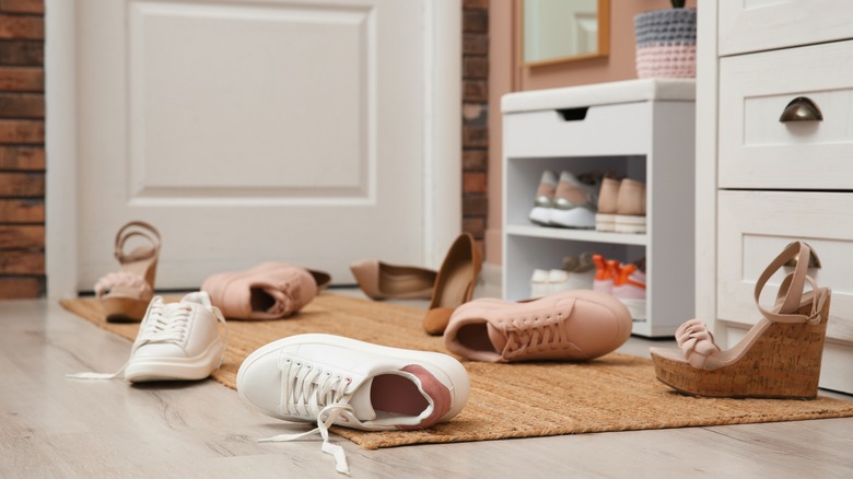 disorganized shoes in mudroom