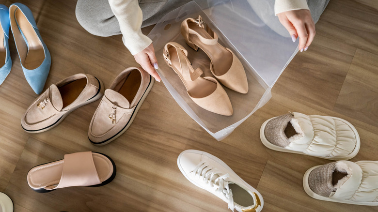 Person sorting through collection of shoes