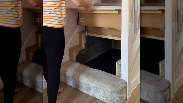 woman lifting stairs to reveal hidden storage underneath