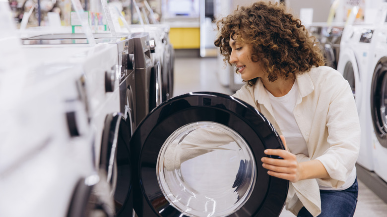 A woman looking inside a washing machine