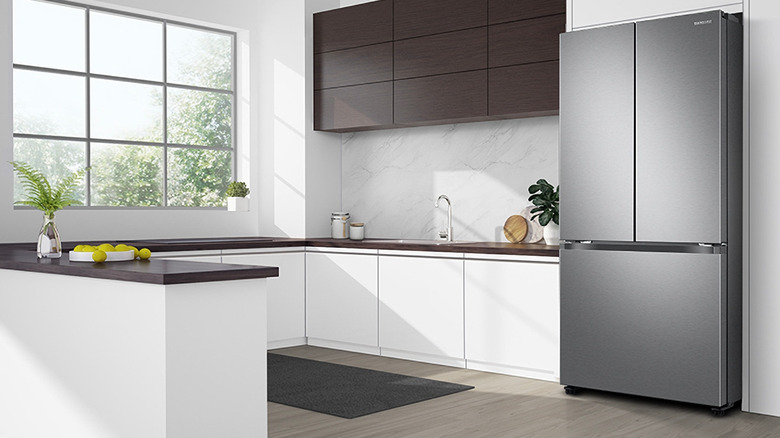A sleek grey refrigerator in a bright kitchen space