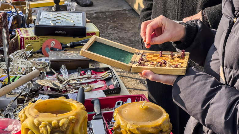 Person inspecting the piece of an item at a garage sale