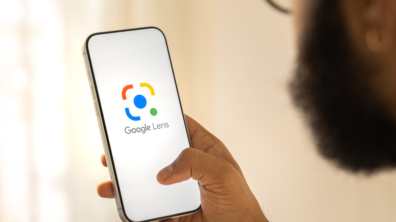 Person opening Google Lens on their phone