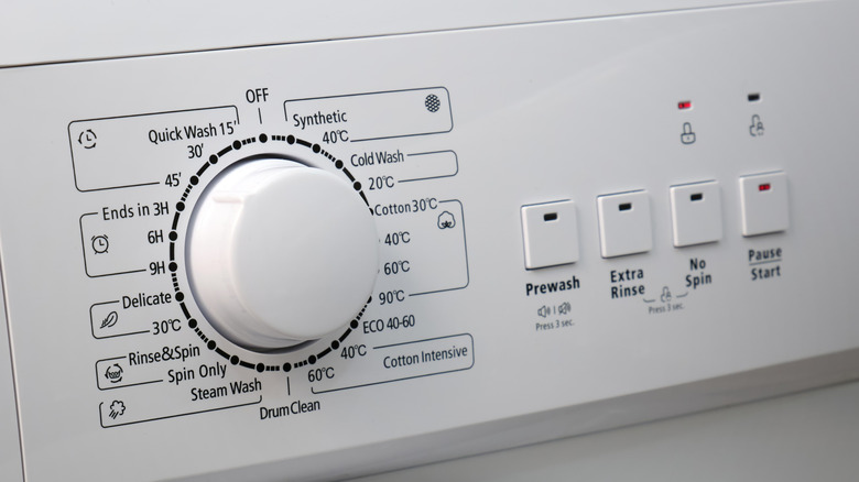 Close up of washer settings dial with drum clean option