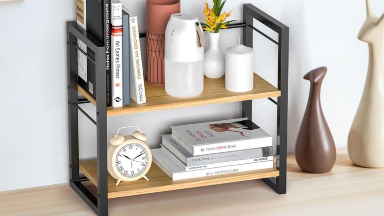 A desktop shelf organizer with wood shelves.
