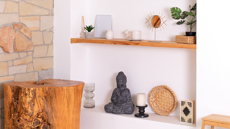 A recessed wall shelf featuring an eclectic mix of home decor.