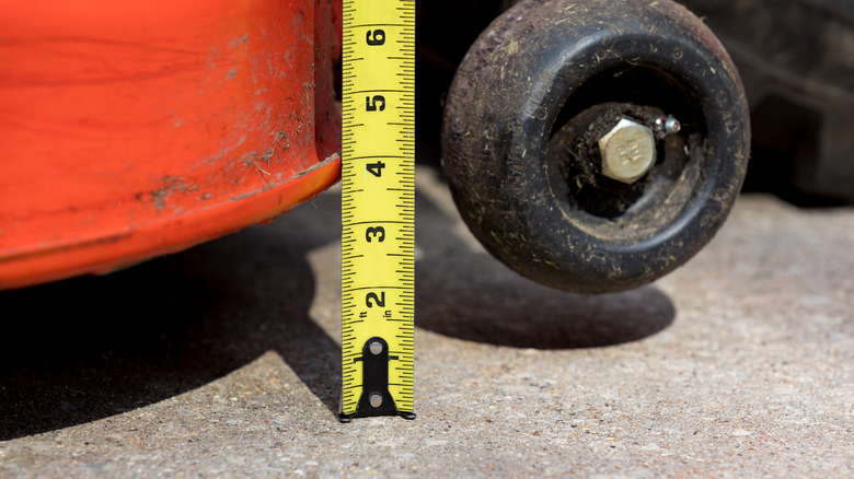 a mower deck wheel and tape measure