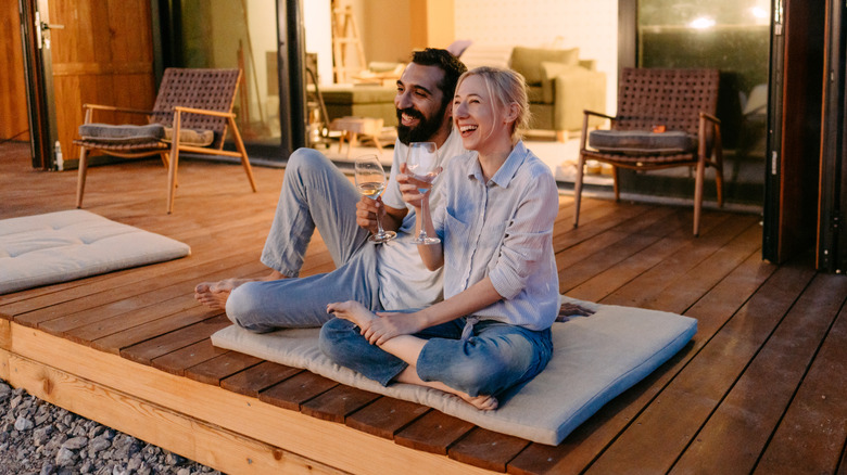 Couple relaxing on wood deck