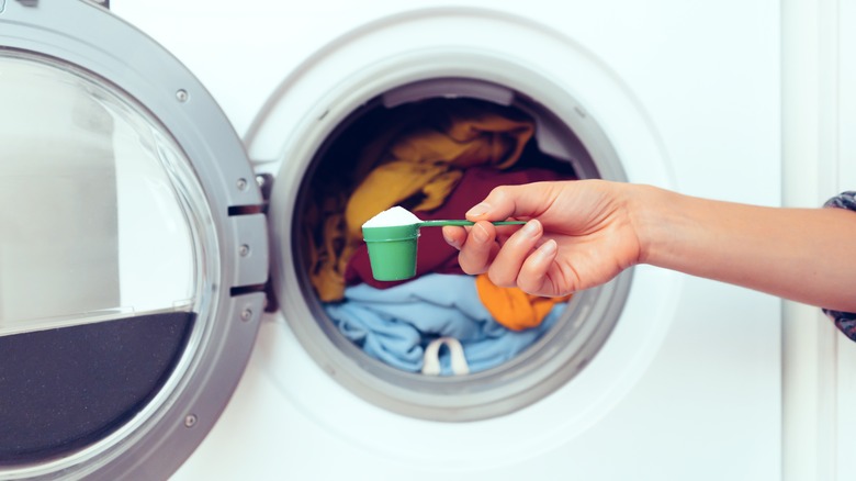 Person with white powder by laundry