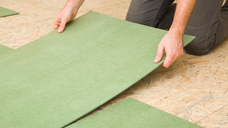 Person placing underlayment