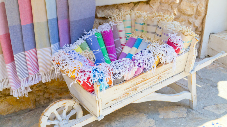 Wooden wheelbarrow full of Turkish towels