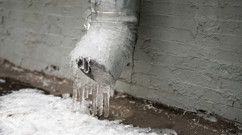frozen home downspout with icicles
