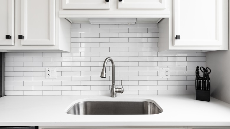 stainless steel sink in white kitchen
