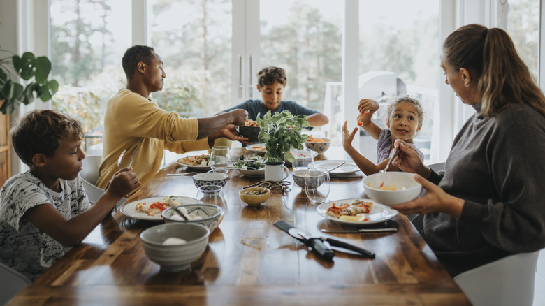 Family enjoying a meal around the dining room table