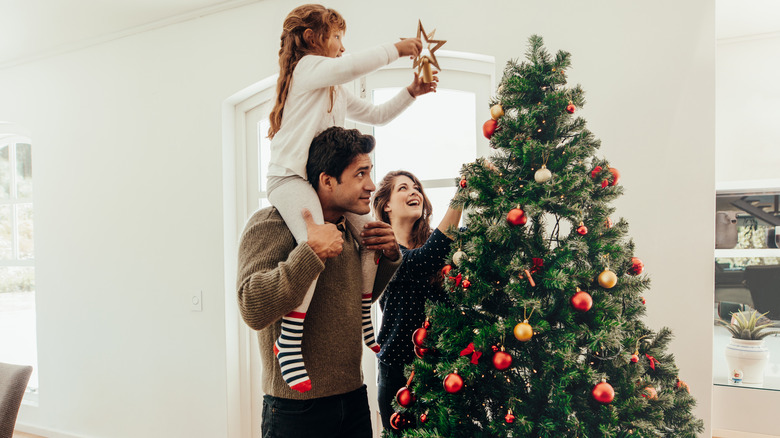family decorating their Christmas tree
