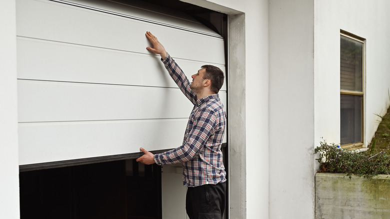 man examining garagae door 