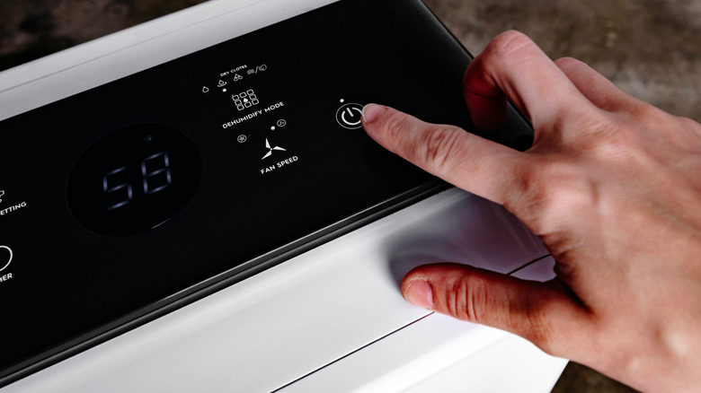 Person setting up a portable dehumidifier