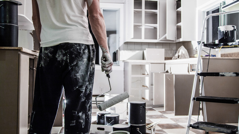 man painting kitchen